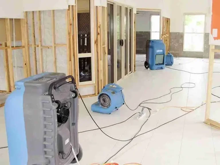 Fans and dehumidifiers drying a room under renovation.